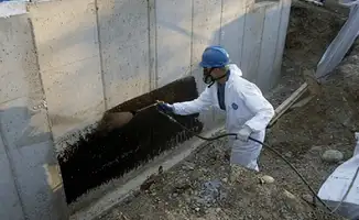 Professional waterproofing the exterior walls of the basement in Marietta, GA