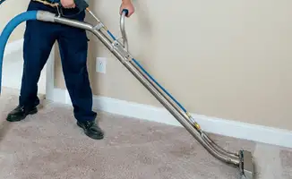 Professional operating a liquid removal machine on a carpeted floor in Marietta, GA